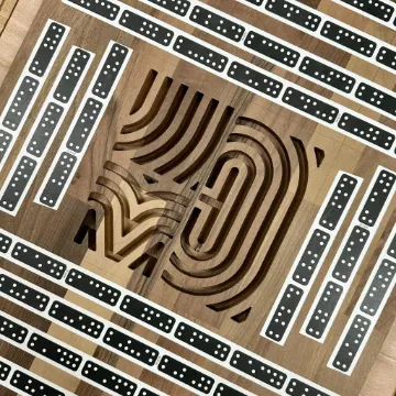 A wooden panel inlaid with a looping monogram, framed by rows of domino tiles