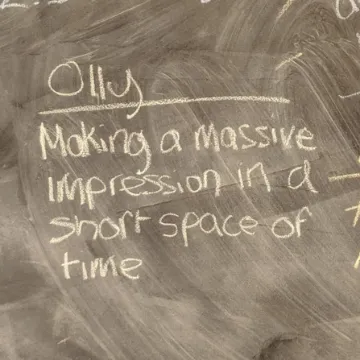 A chalkboard reading “Olly – making a massive impression in a short space of time”