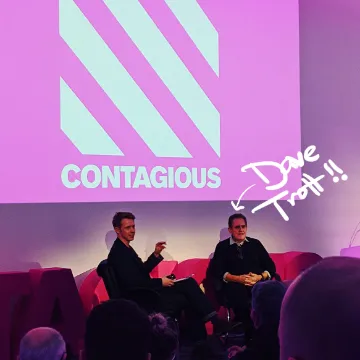 Two men in conversation on stage at a Contagious event, annotated “Dave Trott!!”