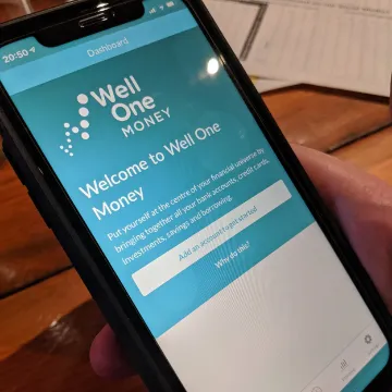 A phone showing the Well One Money app welcome screen